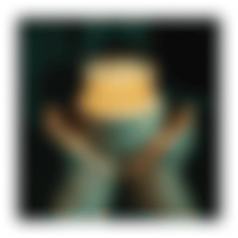 Two hands holding an orange glowing object in a dark, blurry setting.